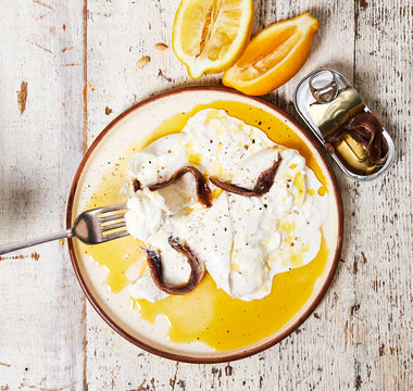 Discover a creamy burrata recipe featuring GOOD PHATS Organic Extra Virgin Olive Oil, anchovies, lemon zest, and a touch of sea salt for the perfect appetiser.